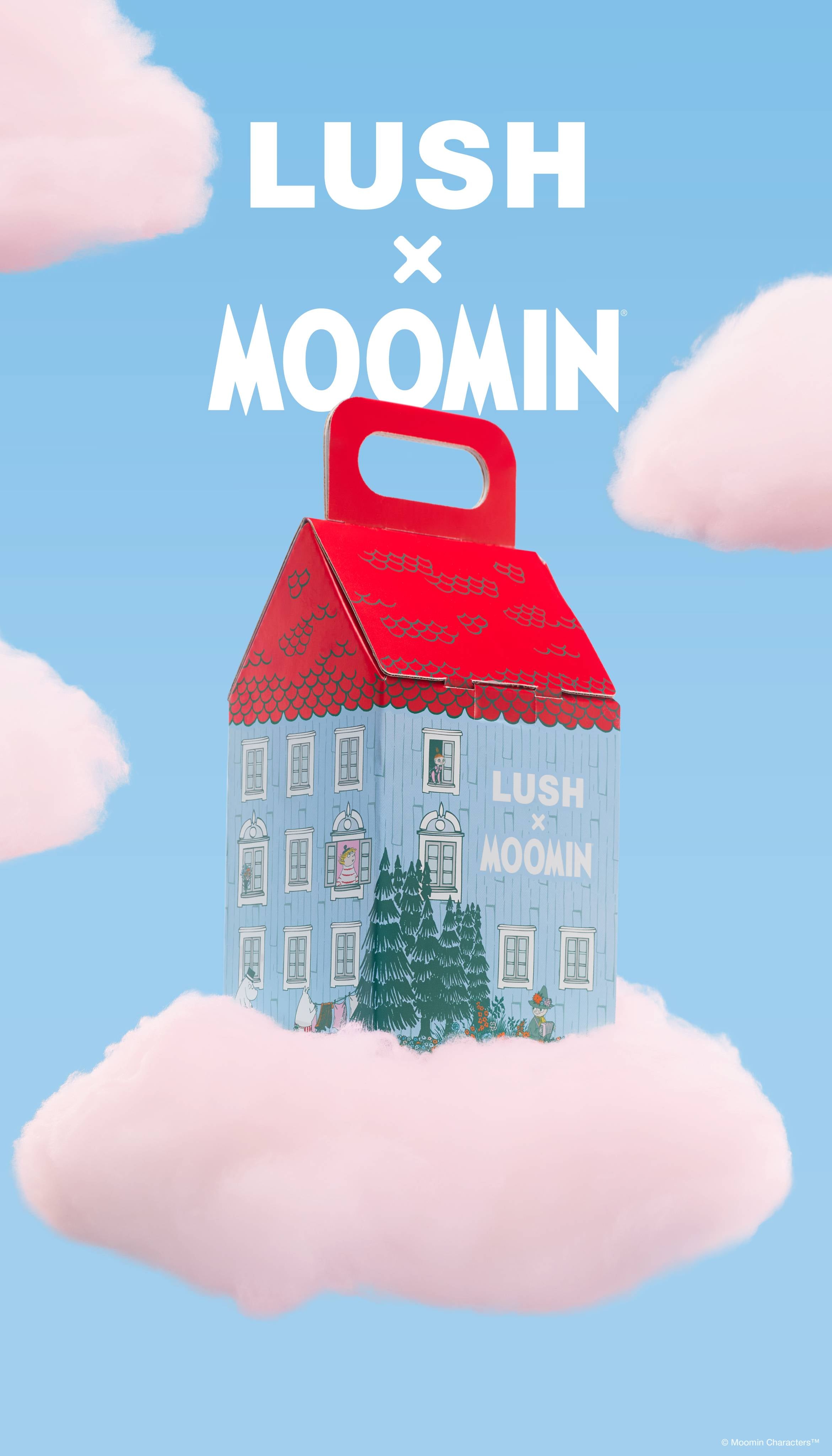 A promotional graphic featuring an illustrated, house-shaped Moomin gift box resting on a fluffy pink cloud. The sky-blue background is filled with scattered pink clouds below bold white text reading "LUSH x MOOMIN".