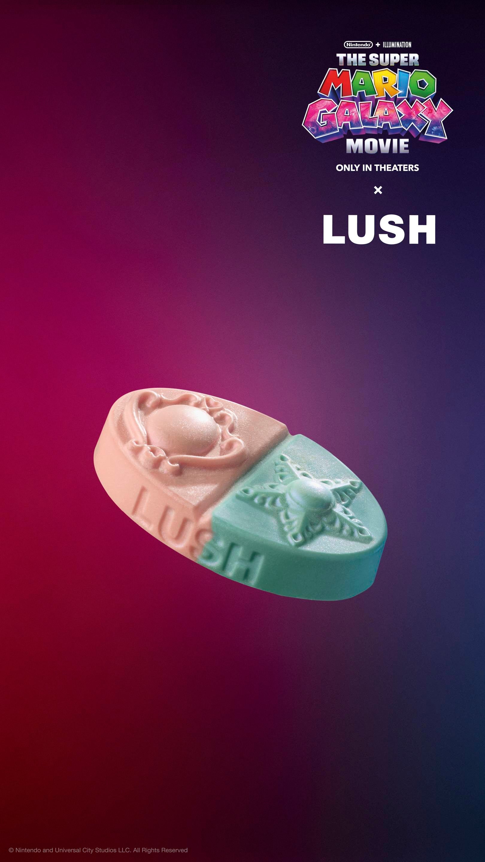 Oval body balm split diagonally into pink and teal with embossed brooch and star designs. Set against a purple-red gradient background with "The Super Mario Galaxy Movie x LUSH" logos. Includes plastic-free glitter.
