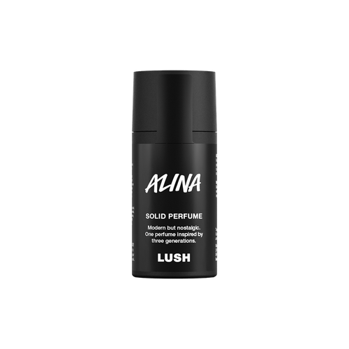Alina. A short, cylindrical black push-up tube of the Alina solid perfume with a black label on the front covering the cap, with the product name and scent printed on it.
