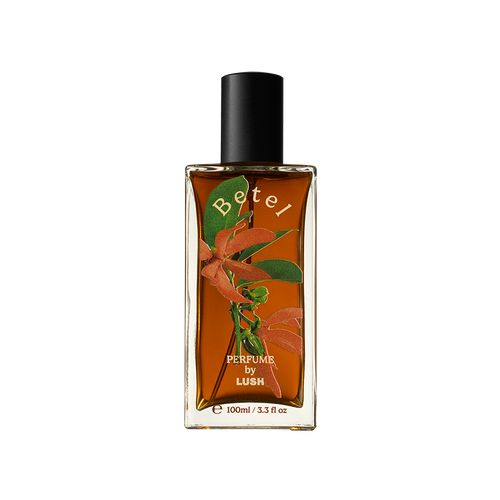 Betel. A rectangular, glass perfume bottle with a black cap is filled with translucent, deep-amber liquid. The name "Betel" is arched in gold letters on the front of the bottle along with flower decals.