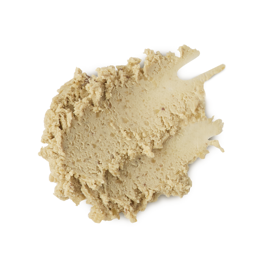 The image shows a neatly smudged swatch of thick, textured, ivory/sand-coloured, paste-like face cleanser product.