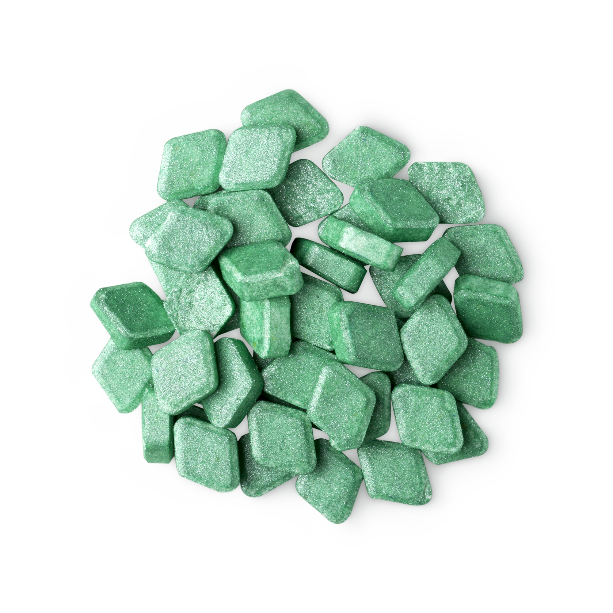A pile of small, diamond-shaped, green Crème De Menthe mouthwash tabs shot from above.
