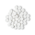 A pile of small, circular, white Dirty toothpaste tabs shot from above.