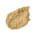 Enzynamite. A round, smudged swatch of pale, golden, creamy face mask with visible textured exfoliating pieces.