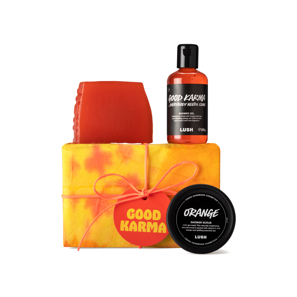 Good Karma. A rectangular box, wrapped in yellow and orange tie-dye paper, tied with orange cord and an orange gift tag.