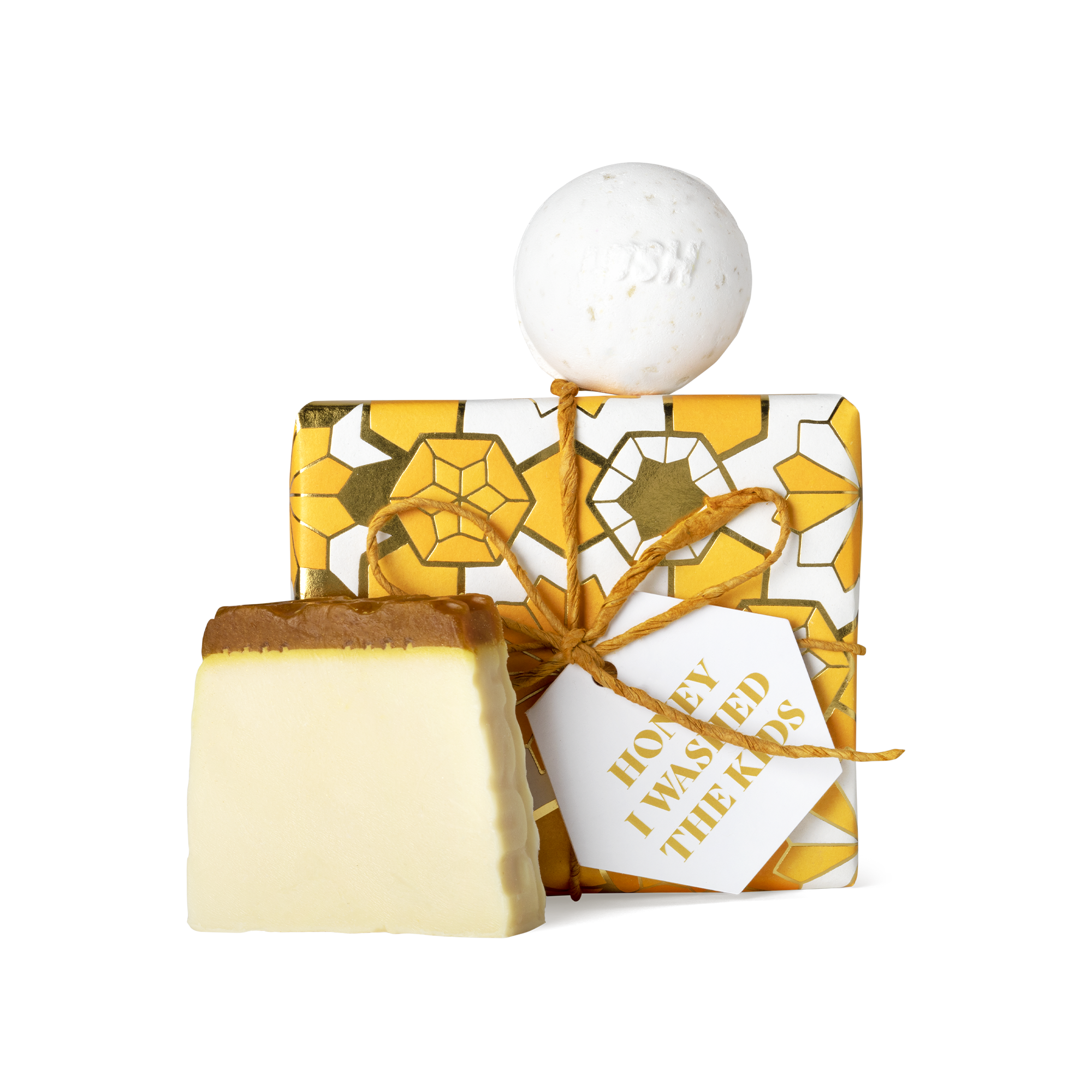 Honey I Washed the Kids. A square box, wrapped in white, yellow, and gold Khadi paper, tied with gold string and gift tag.