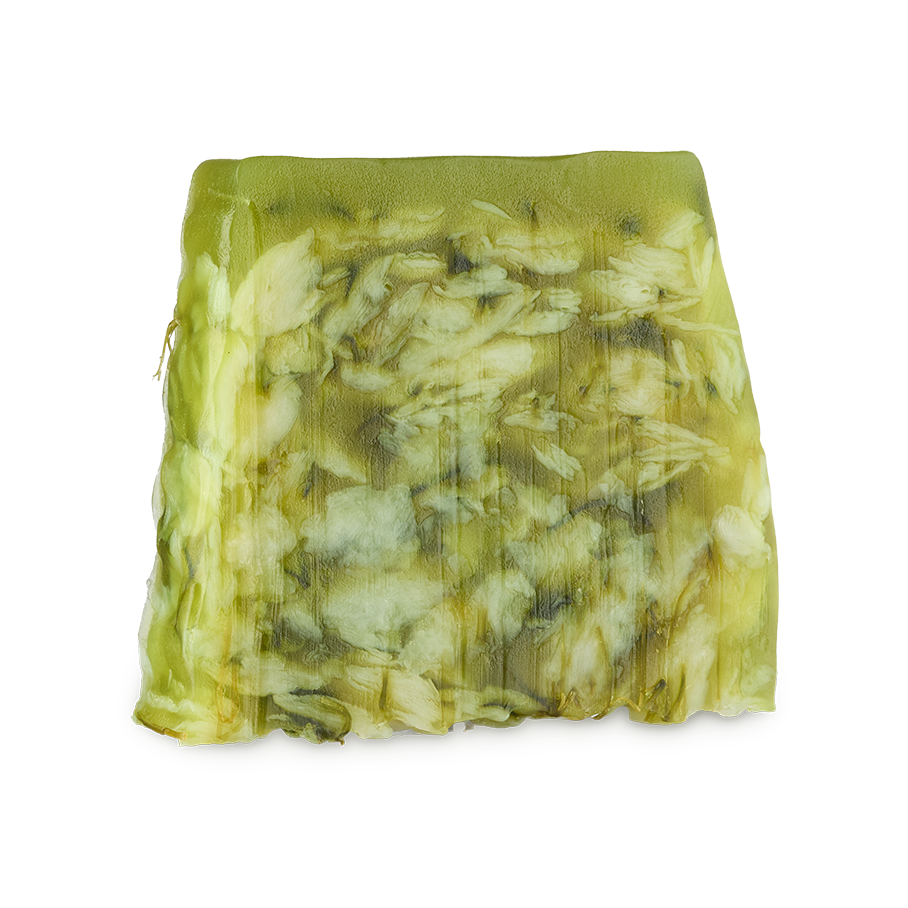 Lemongrass. An off-square slice of translucent green and white soap, marbled with floral/leafy inclusions.