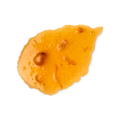 Marmalade body wash. A smudged swatch of thick, translucent orange body wash, resembling marmalade, with visible pieces of fruit zest and pulp. The texture is glossy and slightly bubbly, shown as a single smear.