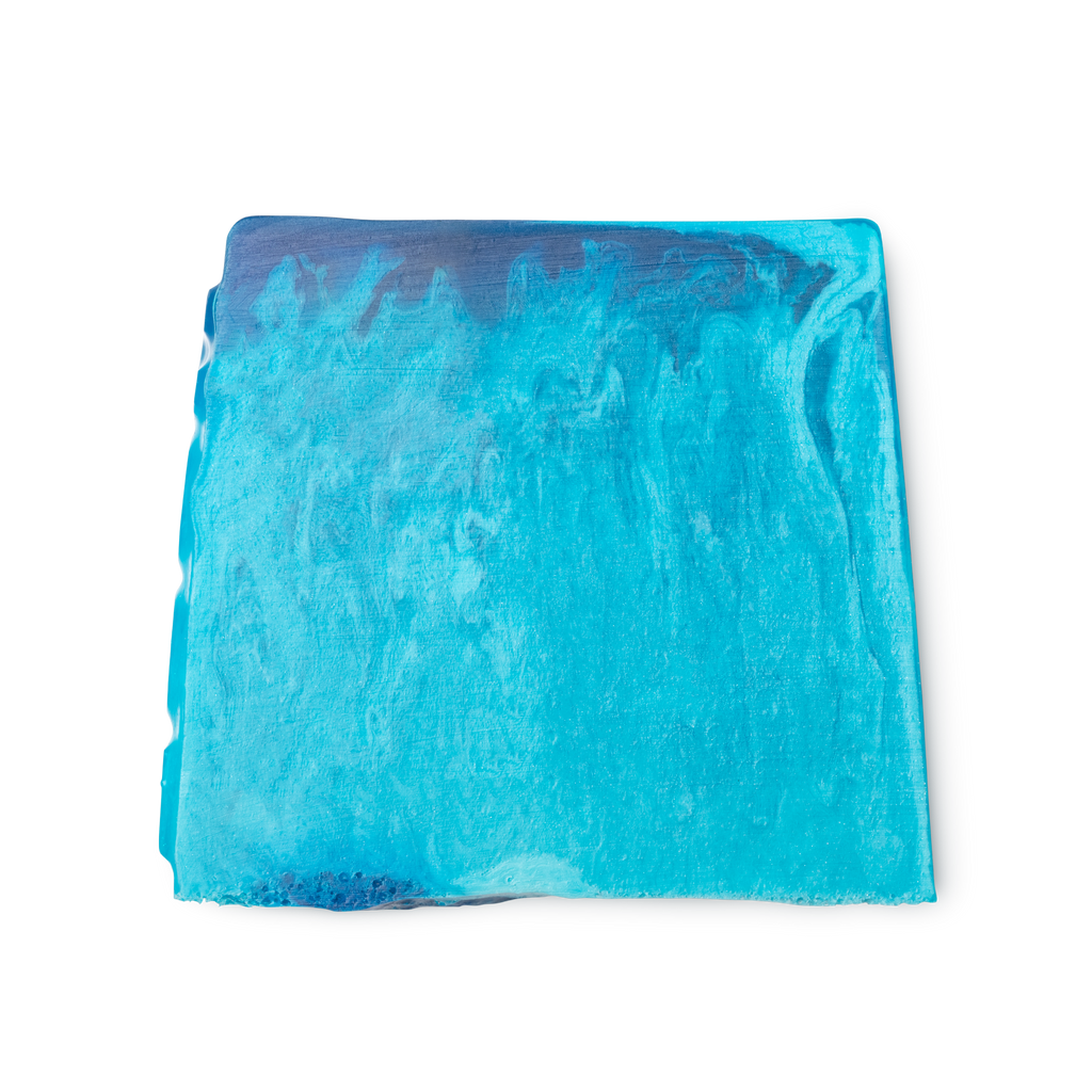 Outback Mate. A bright blue, smooth, trapezium shaped soap, with bumps along its left side and a wavy design in the mix.