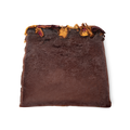 Ro's Argan. A deep purple, moist looking trapezium shaped soap, with a topping of red and yellow rose petals.