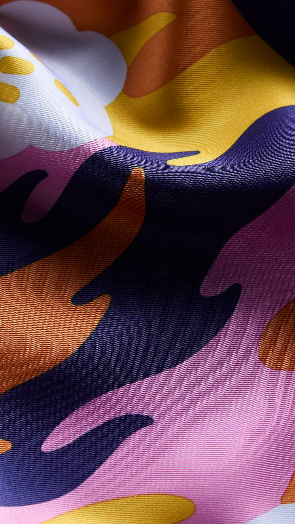 The image shows a super close-up image of the knot wrap. The shot is focused on the texture of the material and the vibrancy of the colours included.