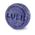 Jumping Juniper. A circular, textured purple Lush solid shampoo bar, embossed with the brand name 'LUSH' across the centre, isolated against a solid black background.