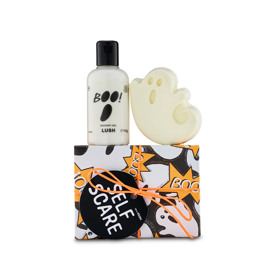 Self Scare. A ghost-patterned box tied with an orange cord sits below a bottle of 'BOO!' shower gel and a white, ghost-shaped bar of soap.