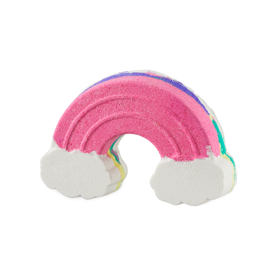 Somewhere. A fun bath bomb, topped with pink but visible layers is shaped like the classic arched rainbow complete with fluffy white clouds.